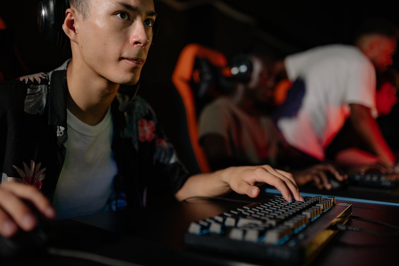 Young adults playing in a competitive esports tournament, deeply focused on gaming.